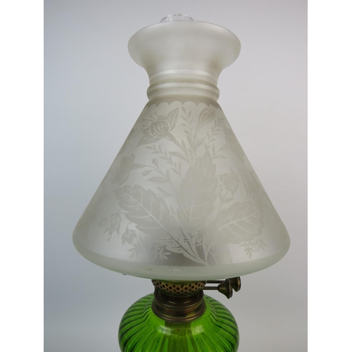 368 - British made antique oil lamp standing on pierced cast metal base, Emerald glass reservoir, glass ch... 