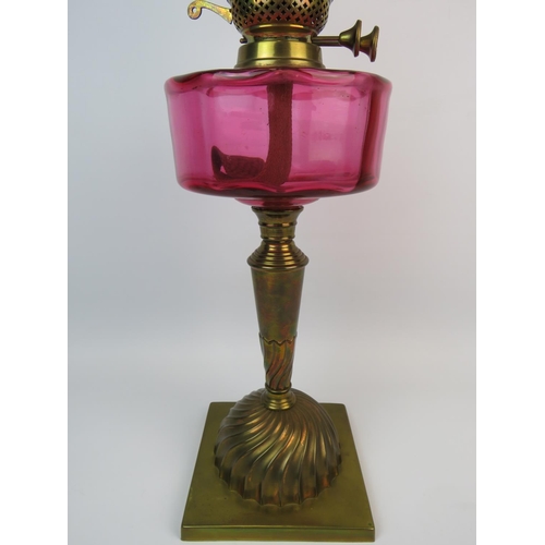 369 - Duplex,  Brass & Glass Antique Oil lamp which has a heavy brass base, Cranberry glass reservoir, Gla... 