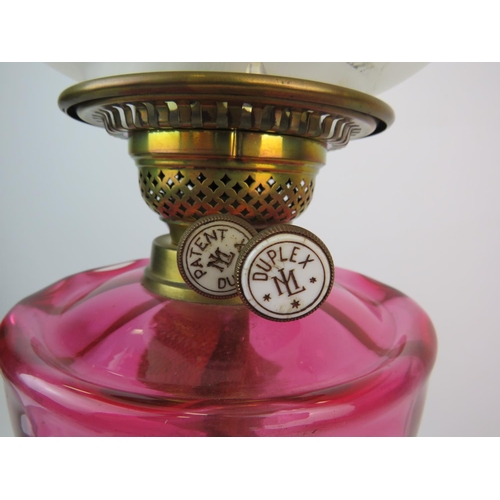 369 - Duplex,  Brass & Glass Antique Oil lamp which has a heavy brass base, Cranberry glass reservoir, Gla... 