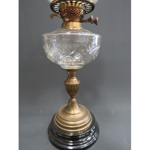 370 - English made, Antique Brass & Glass Oil lamp raised upon a wooden plinth, clear cut glass reservoir ... 