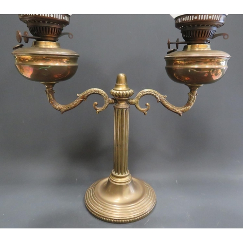 372 - Elegant twin bowl Antique Oil lamp raised on a heavy brass base with reeded column with two brass bo... 