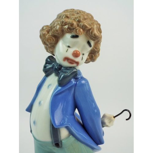 419 - Lladro Nao clown figurine with umbrella and bag.