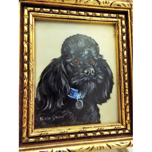 512 - A Pair of framed handpainted miniatures of dogs signed Kay Sney plus a wall plaque.