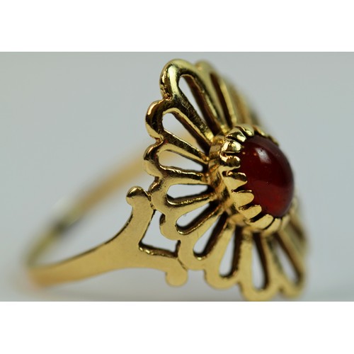 126 - Large, 9ct Gold ring with a pierced surround set with a central red Opal.  Finger size 'S'   2.2g