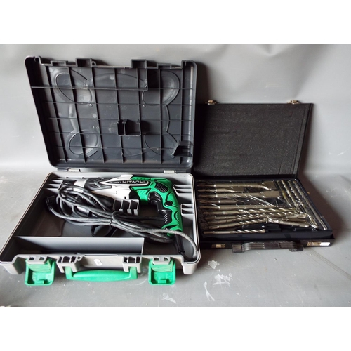 1336 - Hitachi KOKI 24mm rotary hammer drill plus a new set of drill bits.