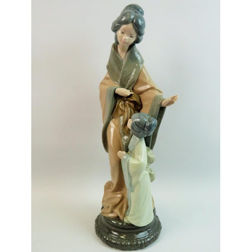 36 - Nao Figurine of Geisha with child. Measures 15 inches tall. See photos.