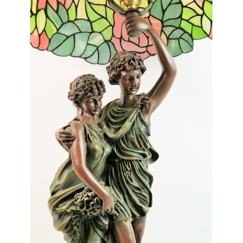 57 - Large figural lamp with tiffany type shade. Measures approx 32 inches tall. See photos.