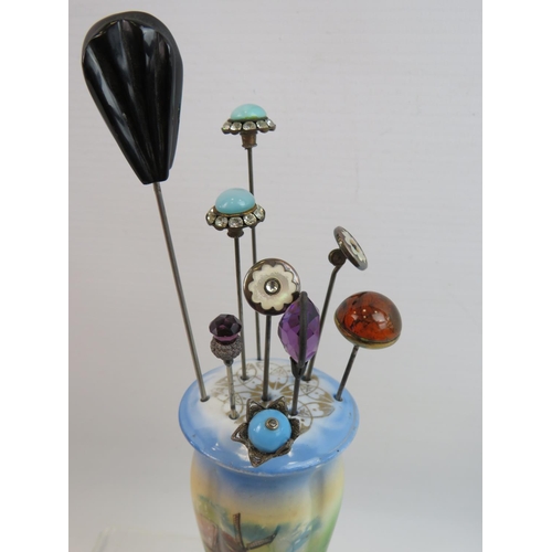 73 - Vintage Hatpin stand together with a collection of Nine hatpins, one of which has an Amber top. See ... 