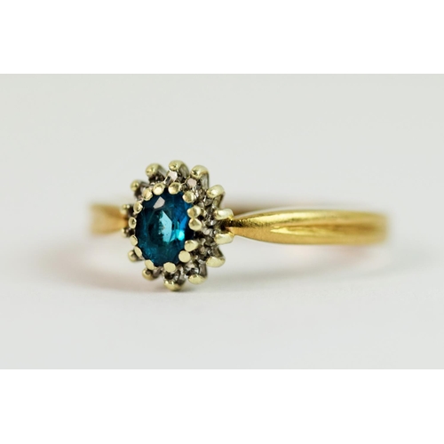 211 - 9ct Yellow gold ring set with an oval central topaz with Diamond halo.  Finger size  'O'   3.1g