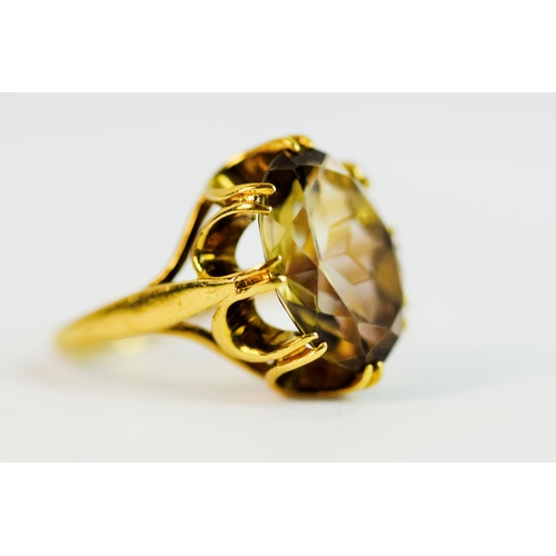 216 - 9ct Yellow gold ring set with a large oval Smokey Quartz held in a fancy basket claw mount. (25 x 10... 