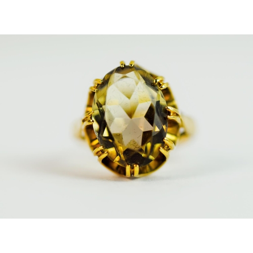 216 - 9ct Yellow gold ring set with a large oval Smokey Quartz held in a fancy basket claw mount. (25 x 10... 