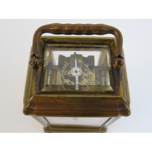 522 - Small brass skeleton carriage clock with glass sides and top to show mechanism and escapement. Comes... 