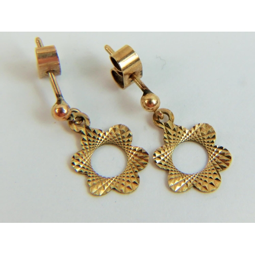 528 - Pretty pair of 9ct Yellow gold earrings as hollow centre flowers. Butterfly fasteners. 1.3g total.