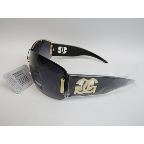 542 - A pair of seemingly new and unused designer sunglasses along with a pair of hinged lens reading glas... 