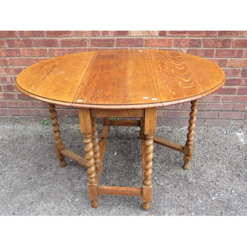 565 - Lovely light oak drop leaf, Oval topped dining table with barley twist legs and gate leg supports.  ... 