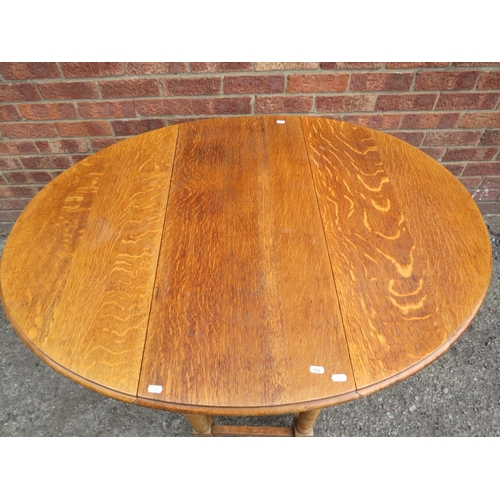 565 - Lovely light oak drop leaf, Oval topped dining table with barley twist legs and gate leg supports.  ... 