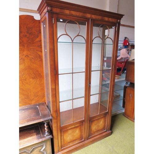 580 - Large glass fronted/glass sided display cabinet with three glass shelves and storage under. Fitted w... 