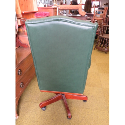 592 - Office chair upholstered in soft green leather in the Chesterfield style. Adjustable height and runs... 