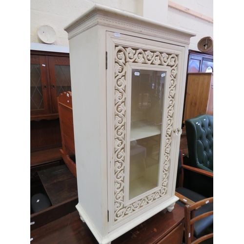 615 - White painted cupboard with pierced decorations to door. Standing on bun feet it measures H:39 X W:2... 