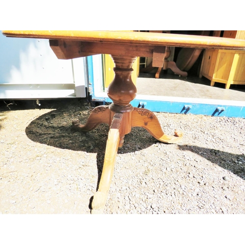 654 - Pine table with central turned column raised on three bracket feet. H:30 x W:47 x D:35 inches see ph... 