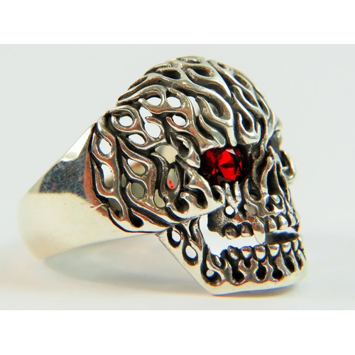 104 - 925 Silver Skull Ring with pierced flame effect decoration and Red gemstone eyes.  Finger size 'Y'  ... 