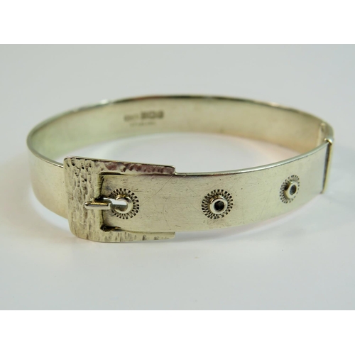 111 - Sterling Silver Buckle decorated hinged bangle with hidden clasp. Halllmarked for Birmingham 1975.  ... 