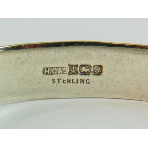 111 - Sterling Silver Buckle decorated hinged bangle with hidden clasp. Halllmarked for Birmingham 1975.  ... 