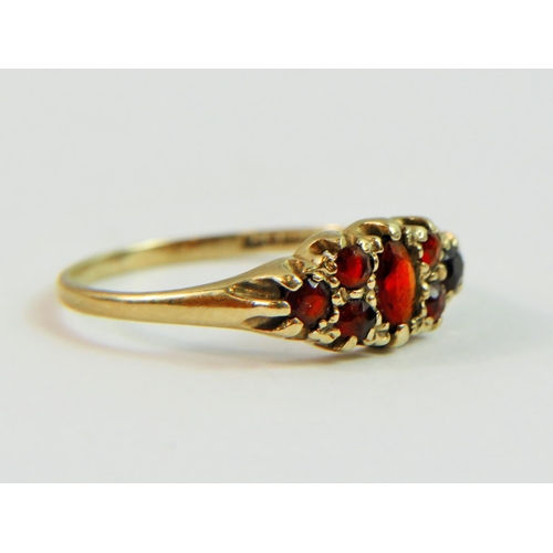 134 - 9ct Yellow Gold Gypsy Style ring set with multiple Garnets.  Finger size 'P'   1.5g