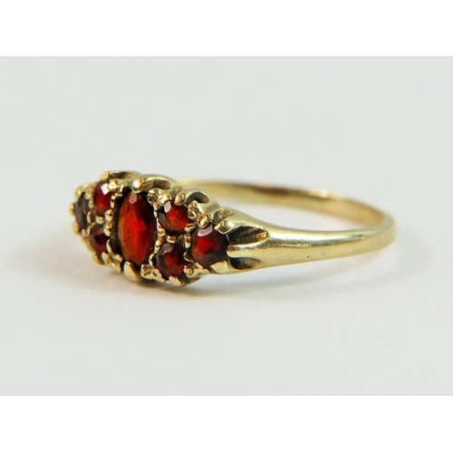 134 - 9ct Yellow Gold Gypsy Style ring set with multiple Garnets.  Finger size 'P'   1.5g