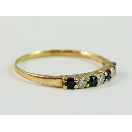 146 - 9ct Yellow Gold ring set with Three Diamonds and Four Sapphires.   Finger size 'N-5'   1.0g