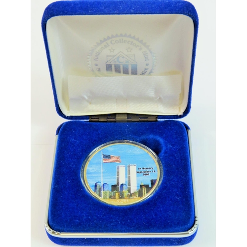 156 - 2001 Gold plated and enamel, Silver one dollar Twin Towers commemorative coin set in a velvet lined ... 