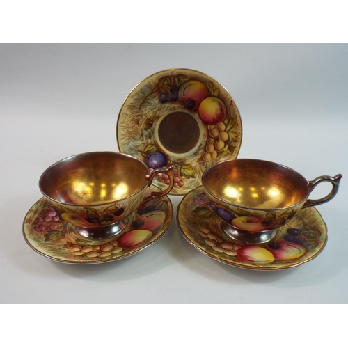 219 - 2 x Aynsley Orchard gold cups and saucers plus one spare saucer, signed D jones & N Brunt.