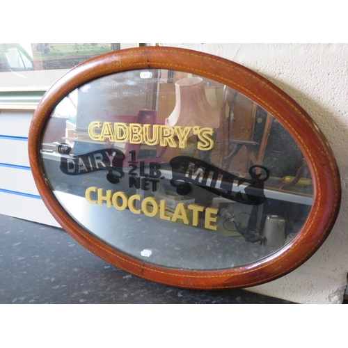 446 - Cadburys Choclate advertising mirror in an oval inlaid vintage frame. 32 x 22 inches. See photos.