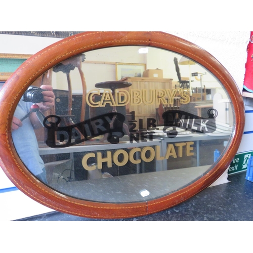 446 - Cadburys Choclate advertising mirror in an oval inlaid vintage frame. 32 x 22 inches. See photos.