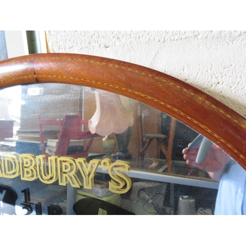 446 - Cadburys Choclate advertising mirror in an oval inlaid vintage frame. 32 x 22 inches. See photos.