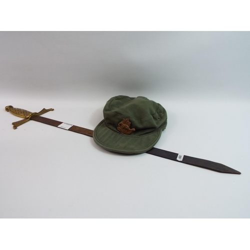 336 - Decorative sword and a military cap with cap badge.