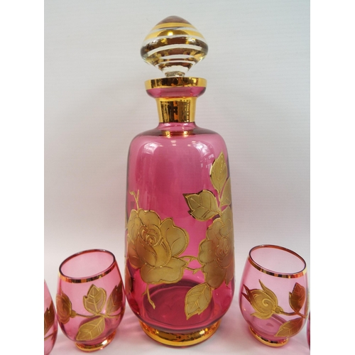 374 - Pink glass decanter with gold overlay floral design and 6 matching glasses