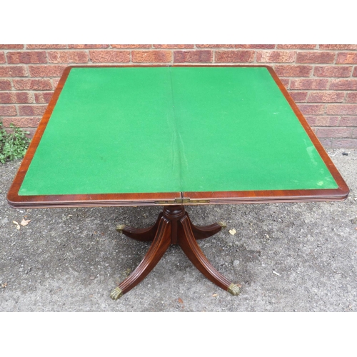 517 - Mahogany, folding top card/games table with green baise cover. Side compartment contains many packs ... 