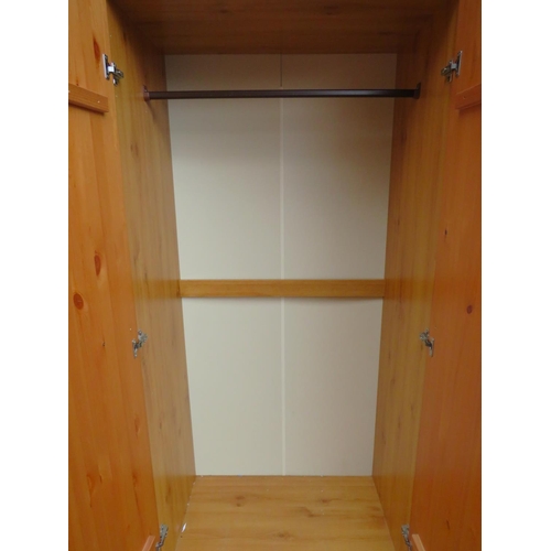 519 - Pine effect two plus one wardrobe with solid pine doors. H:73 X W:47 X D:20 inches.