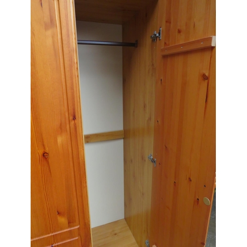 519 - Pine effect two plus one wardrobe with solid pine doors. H:73 X W:47 X D:20 inches.