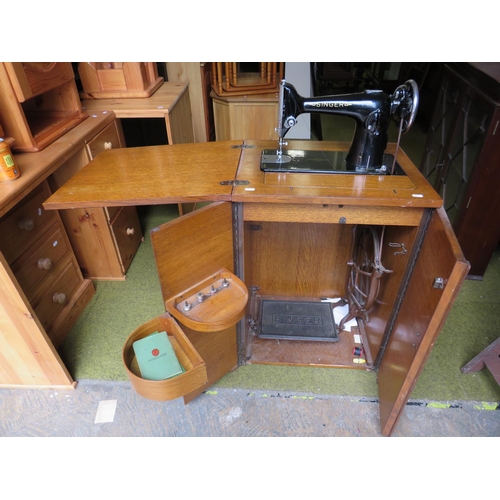 524 - Vintage Singer Treadle Sewing machine with original cabinet. Appears to be in working order. See pho... 