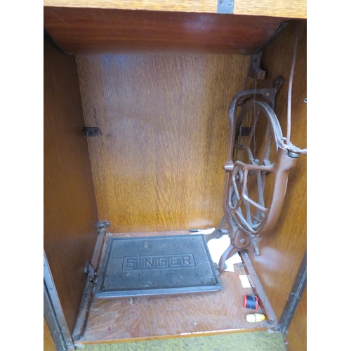 524 - Vintage Singer Treadle Sewing machine with original cabinet. Appears to be in working order. See pho... 