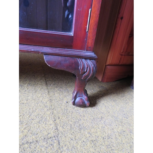 529 - Darkwood glazed fronted bookcase with three wooden shelves, mounted on ball and claw feet with short... 