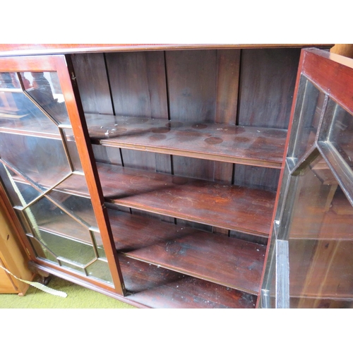 529 - Darkwood glazed fronted bookcase with three wooden shelves, mounted on ball and claw feet with short... 