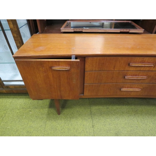 546 - Mid 20th Century Teak dresser by Beautility.  Unusual concave front with three long central drawers ... 