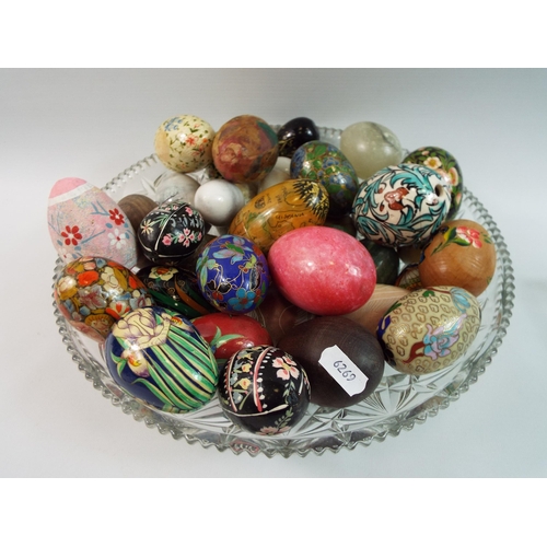 386 - Large crystal bowl full of Oynx, wood and enamel decorative eggs.