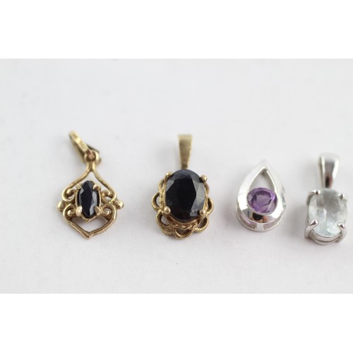 709 - 4 x 9ct yellow & white gold gemstone pendants inc. sapphire, amethyst & quartz (2.3g)     752616