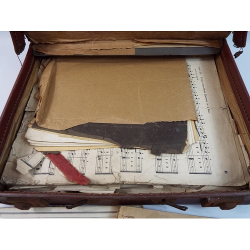 493 - Vintage leather case containing piano and sheet music.