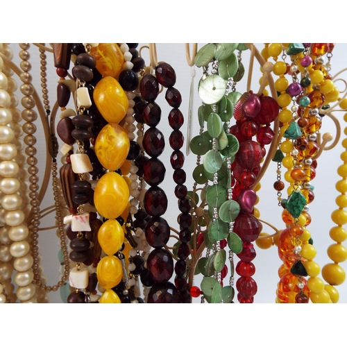 724 - Large quantity of vintage costume jewellery necklaces on stands.