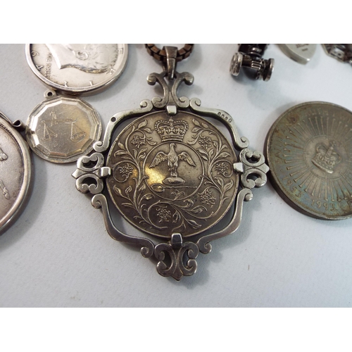 729 - Sterling silver mounted and unmounted coins, charm bracelets and pendants a total of 290grams of sil... 